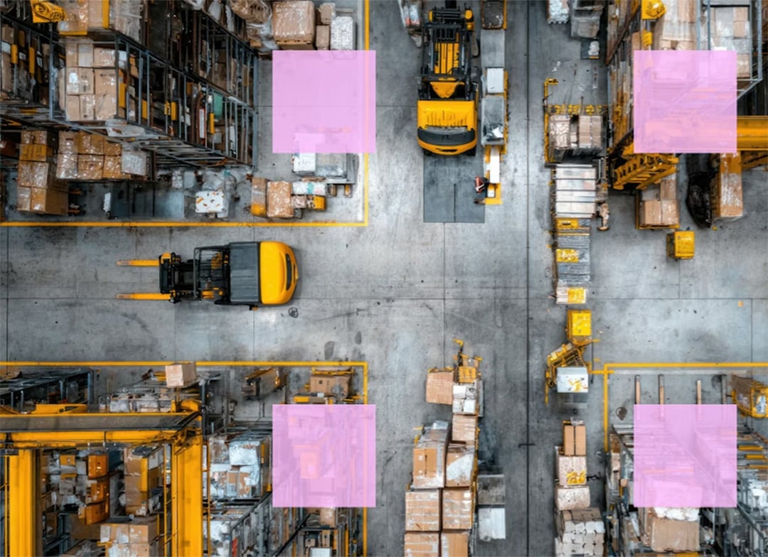 Two material handling machines moving packages in a warehouse.