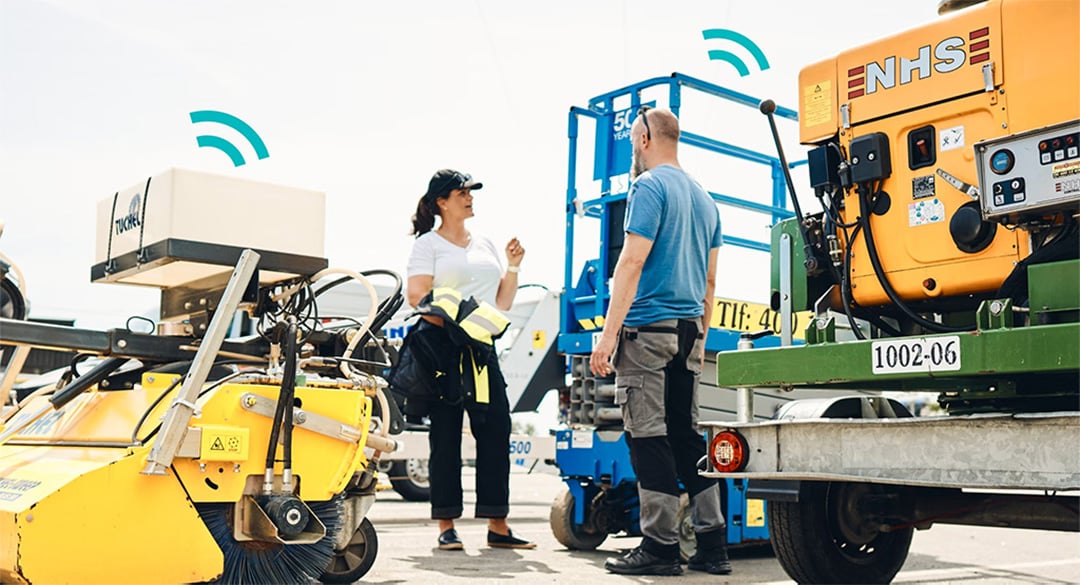 Two employees (a man and a woman) are talking among the machines.