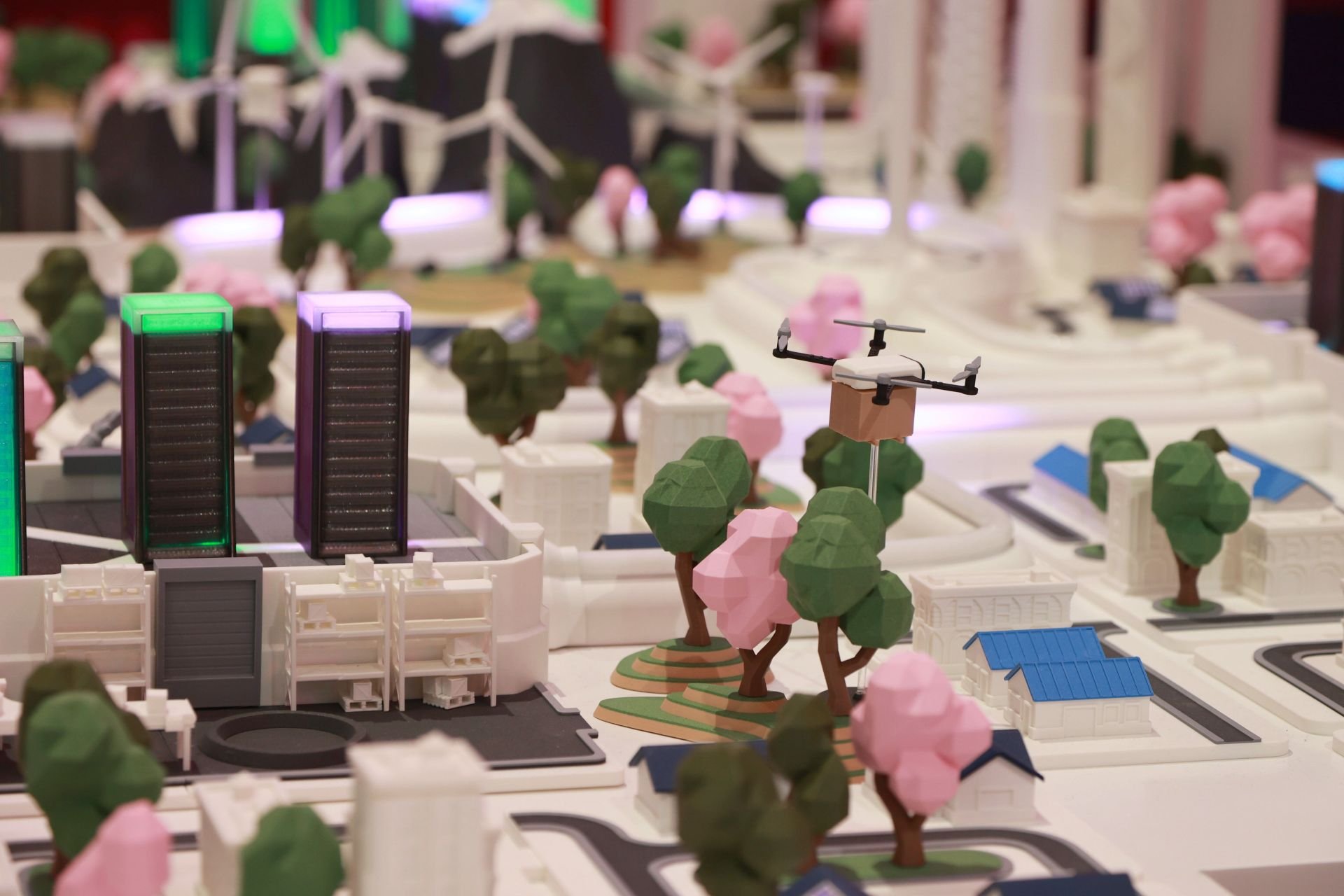 Close-up from the digital twin of the product that shows 3D printed city with colorful buildings and trees.