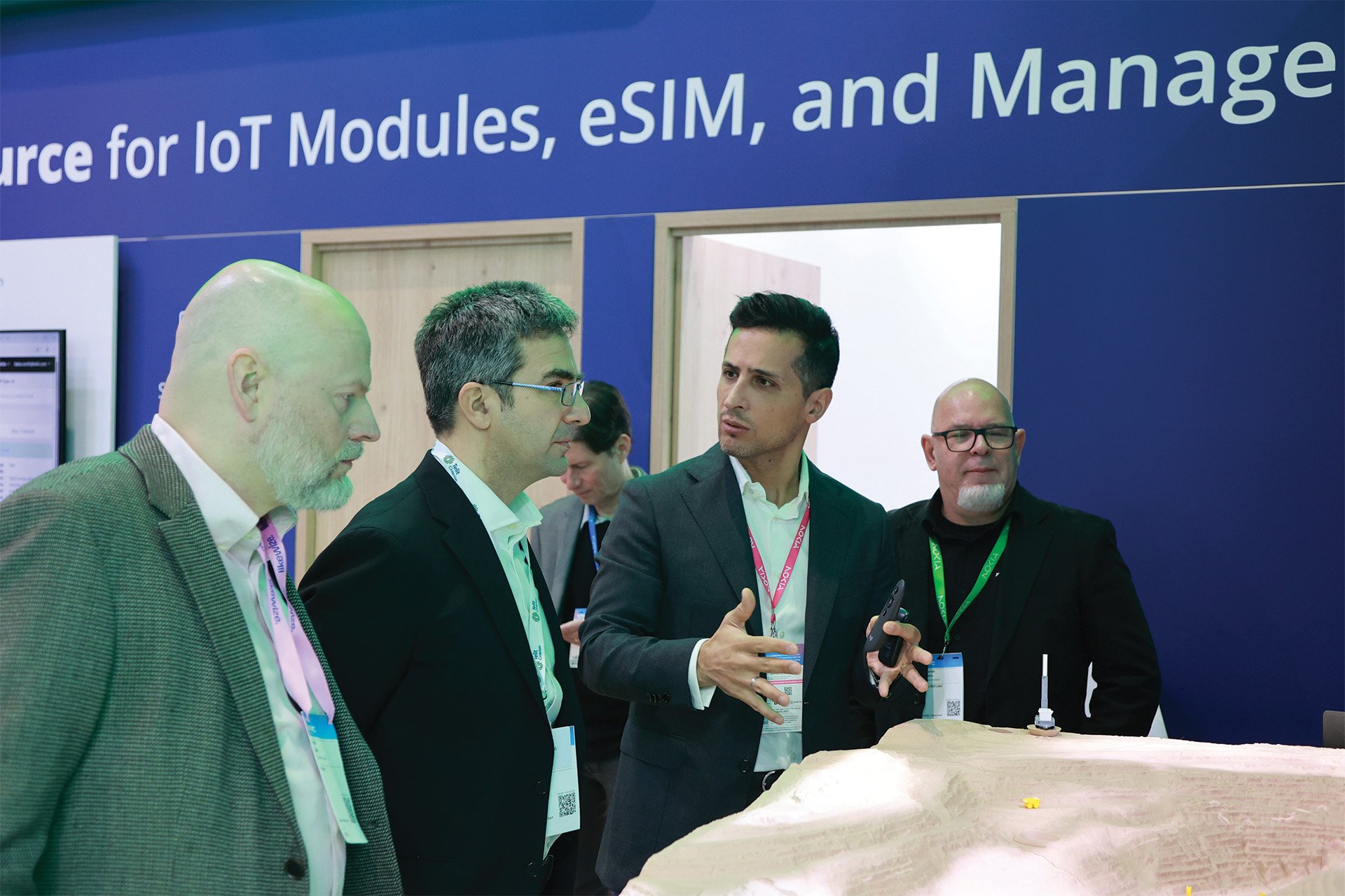 Digital twin the product on display at a trade fair, with people examining it.